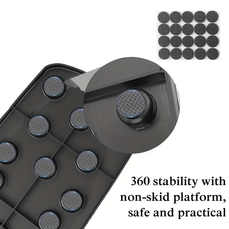 Black tray with circular protrusions and text highlighting stability and safety.